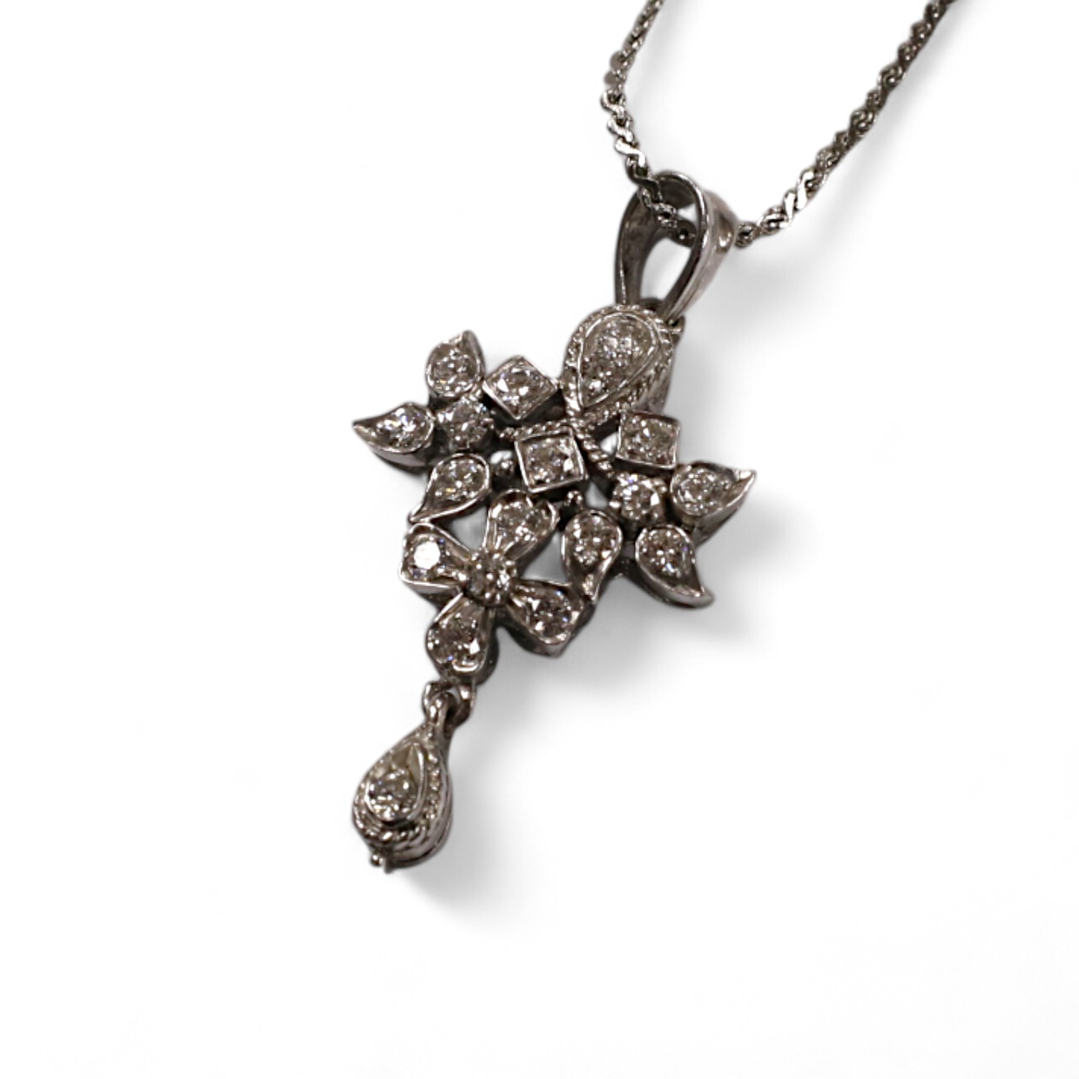 A modern white metal and diamond chip cluster set drop pendant, 33mm, on a base metal chain. Condition - fair